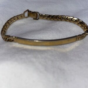 Vintage AVON signed gold tone curved bar bracelet fold over signed clasp